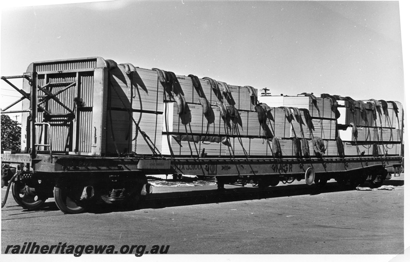 P10389
A WQX class standard gauge wagon, with adjustable bulkhead, carrying a load of packed timber sheets. Note the use of rubber straps to protect the wood.
