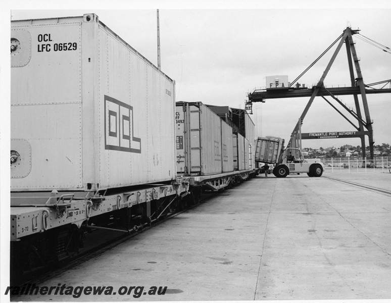 P10692
Containers being loaded onto rail wagons at North Wharf Fremantle. Note the container crane in the background.
