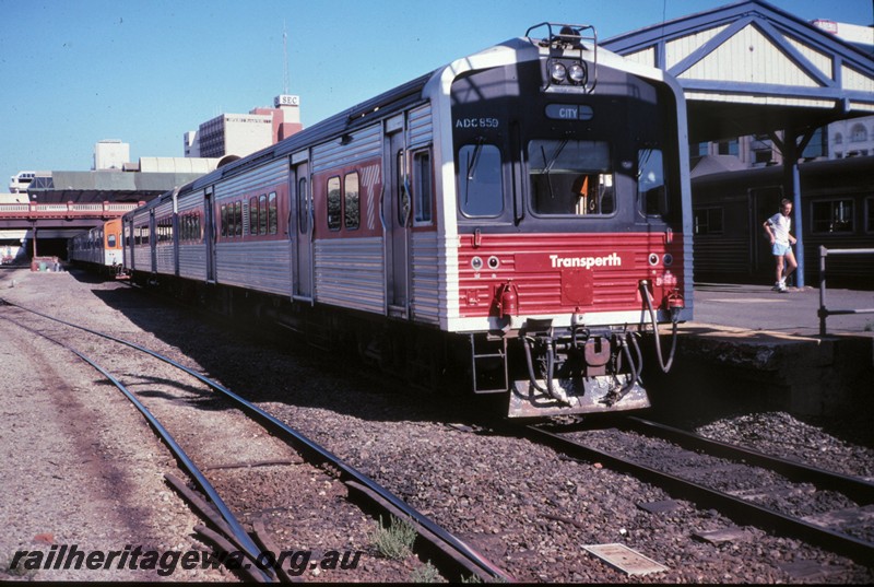 P12861
ADC class 859 railcar trailer on ADL/ADC set with red and black front, Perth Station, side and front view.
