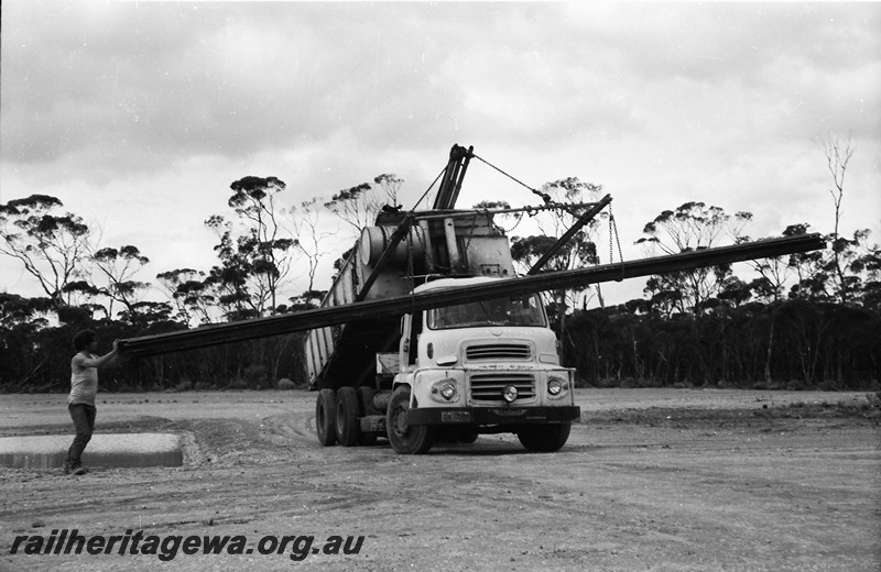 P13553
2 of 4 images of loading/unloading rails at Beete, CE line, tip truck being used as a crane to lift the rails
