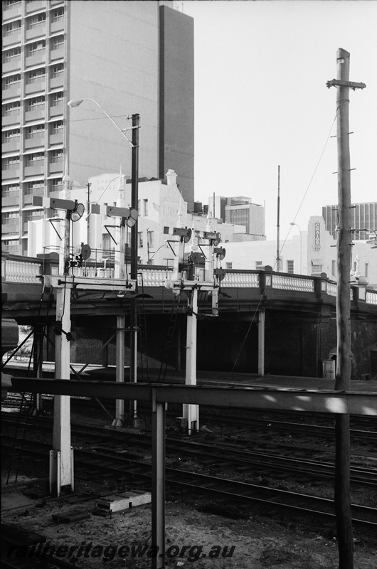 P14036
Bracket signals with shunting dollies near the Barrack Street Bridge, Perth Station, view across the tracks looking south.
