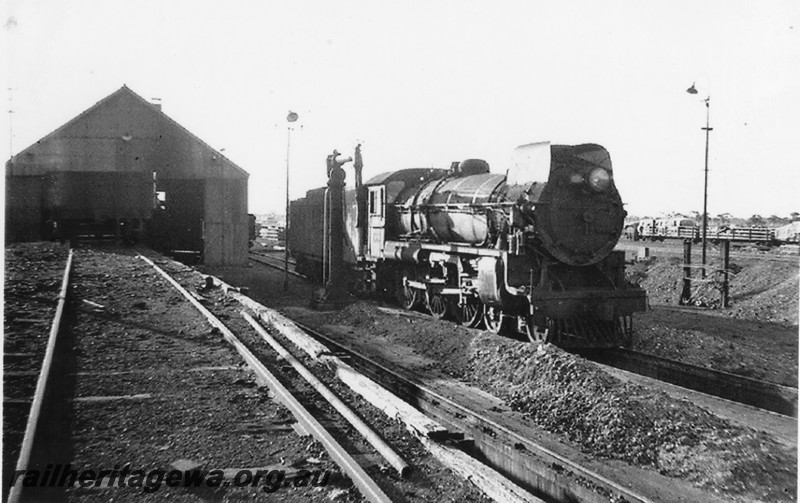 P14215
Commonwealth Railways (CR) C class 63, elevated coaling platform, water column, Parkeston Locomotive Depot.
