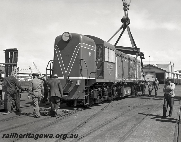 P14482
C class 1703, Fremantle Harbour, front and side view, being lowered onto the wharf from the 