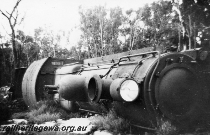 P14701
1 of 3, FS class 427 steam locomotive derailed near Muja on the Muja-Centaur-Collie line, BN line, view of loco on its side. Date of derailment 23/8/1955
