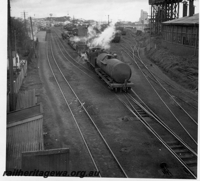 P14830
G class 223 steam locomotive shunting, tracks, round house and water tower, Bunbury, SWR line.
