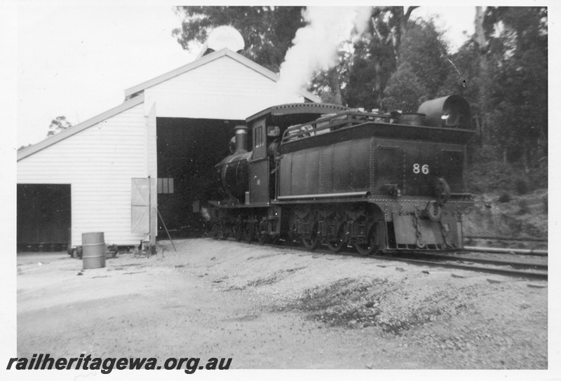 P14853
1 of 2, Bunnings YX class 86 steam locomotive, side and end view, loco shed, Donnelly River Mill.
