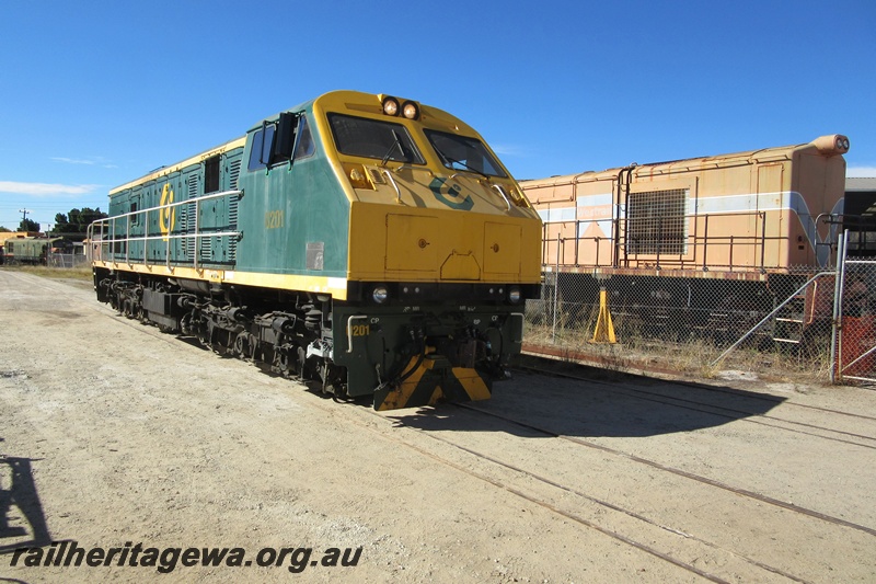 P15071
Public Transport Authority (PTA) loco, U class 201 passing through the Rail Transport Museum site heading towards the UGL plant, Bassendean, side and front view
