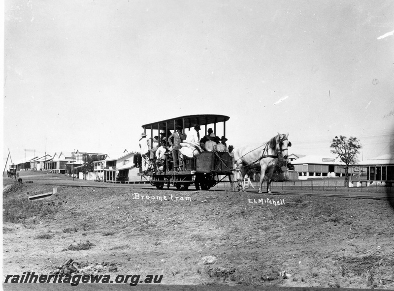 P15114
A horse drawn tram pictured in Broome with a sizeable crowd. Portion of the township in the background.
