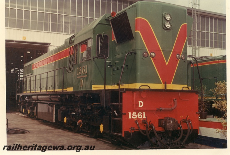 P15891
D class 1561, in green with red and yellow stripe livery, standing outside shed, side and front view
