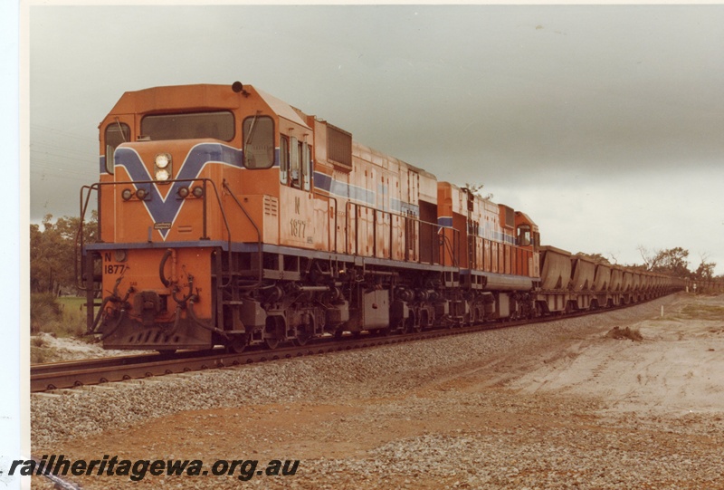 P15892
N class 1877 and another diesel loco, in Westrail orange with blue and white stripe, double heading bauxite train, rural setting, front and side view

