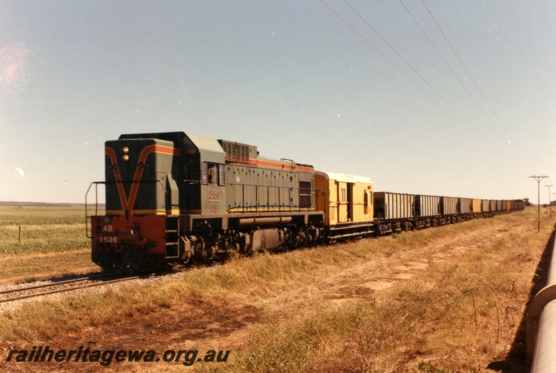 P15921
AB class1536, on ballast train comprising WSH class hoppers and van, rural setting, front and side view

