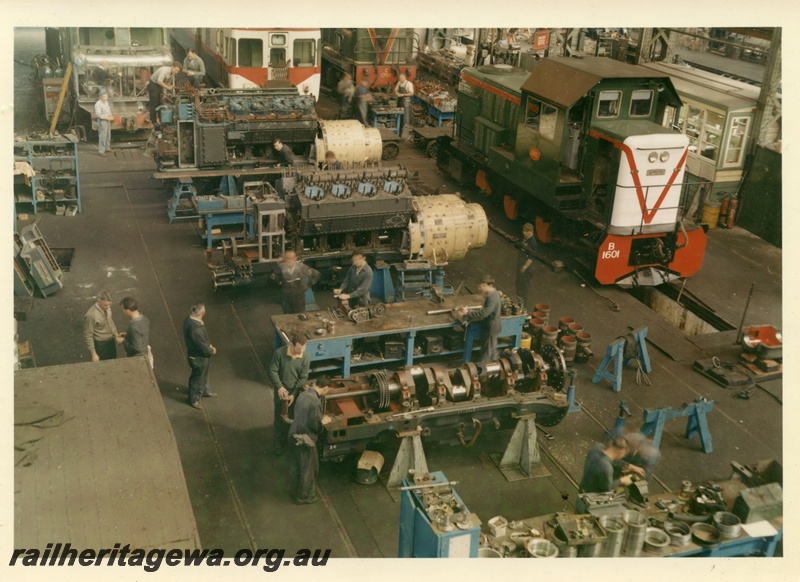 P15980
Several diesel engines, stripped down, staff working on them, B class 1601 in green with red stripe and white end, C class 1701 in green with red and yellow stripe, Diesel Shop, Midland Workshops, interior view from elevated position
