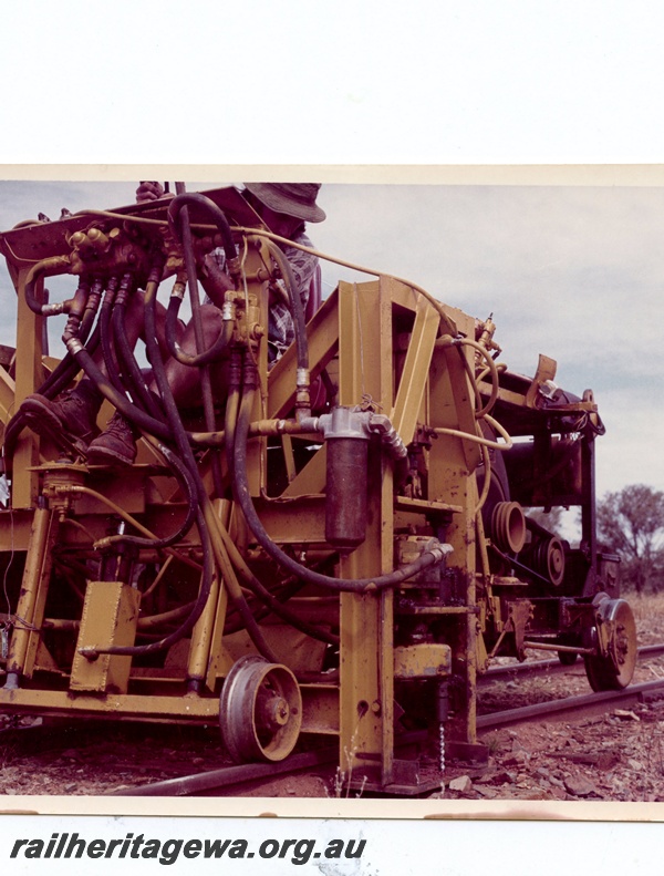 P15997
Mobile track maintenance machine, in yellow colour scheme, with operator, front and side view
