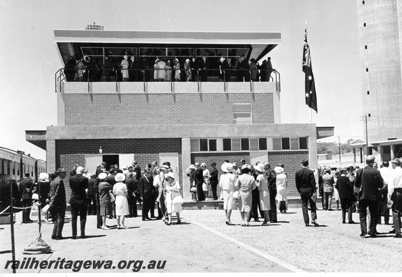 P16086
The official opening of the Yardmaster's Building at Avon Yard. Guests and officials viewing the exterior & interior of the building. Note portion of the CBH Silo under construction at the right of the photo.
