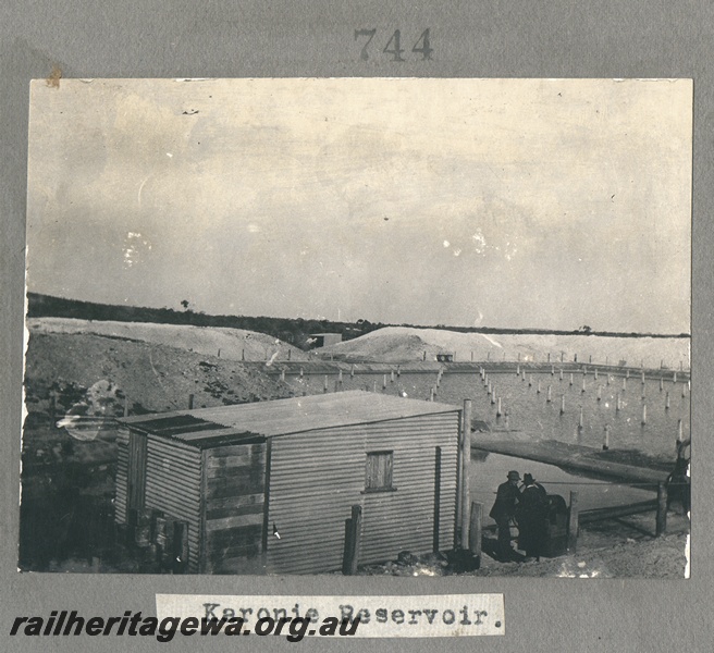 P16158
Commonwealth Railways (CR), water reservoir, corrugated iron hut, Karonie, TAR line, overview 
