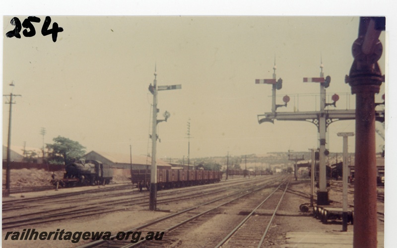 P16241
Station yard, steam loco, rake of wagons, signal, bracket signal, water tower, Northam, ER line, view from east end of station platform
