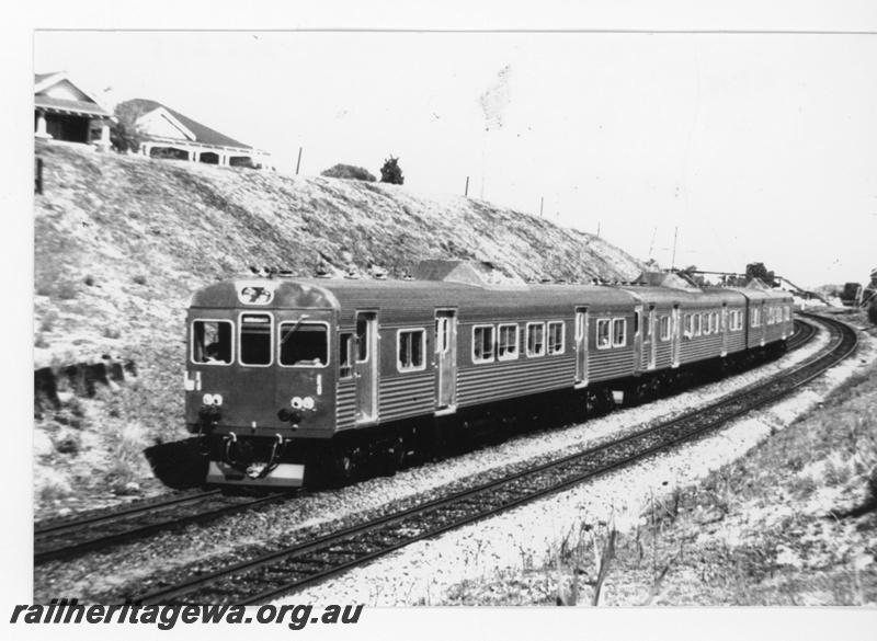 P16415
ADK class three railcar set, passing through cutting, houses, footbridge, Victoria Park, SWR line, front and side view

