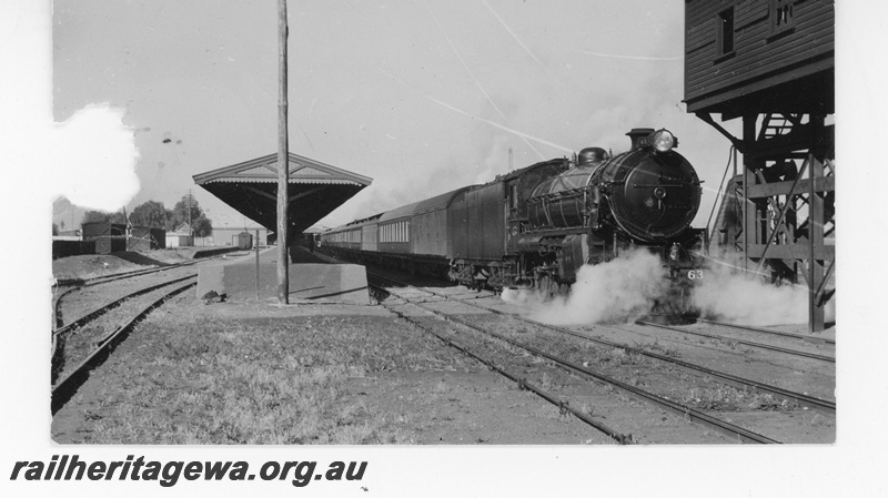 P16461
Commonwealth Railways (CR) C class loco on passenger train, platform, canopy, water tower, Kalgoorlie, TAT line
