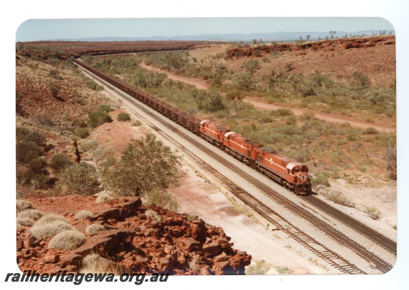 P16746
Mount Newman (MNM)180 car loaded ore train at Hesta.
