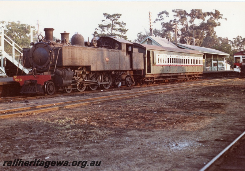 P17054
DD class 593 hauling the 6.10pm Armadale - Perth train. SWR line, Note portion of the footbridge to right of locomotive, station building and Railcar in background.

