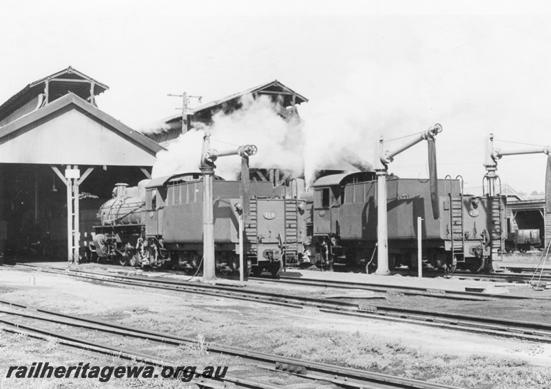 P17056
PM class718 and PM class 705 at the western end of East Perth loco. Note the store shed in the right background, the water columns and the two tender ladders on the locomotive.
