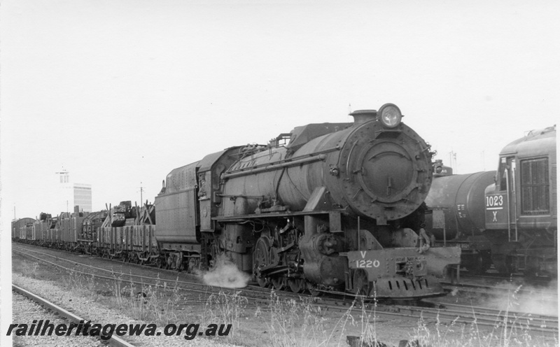 P17173
3 of 3, V class 1220 steam locomotive side and front view on the number 56 goods train, Fremantle Port Authority building in the background, cab of X class 1023 
