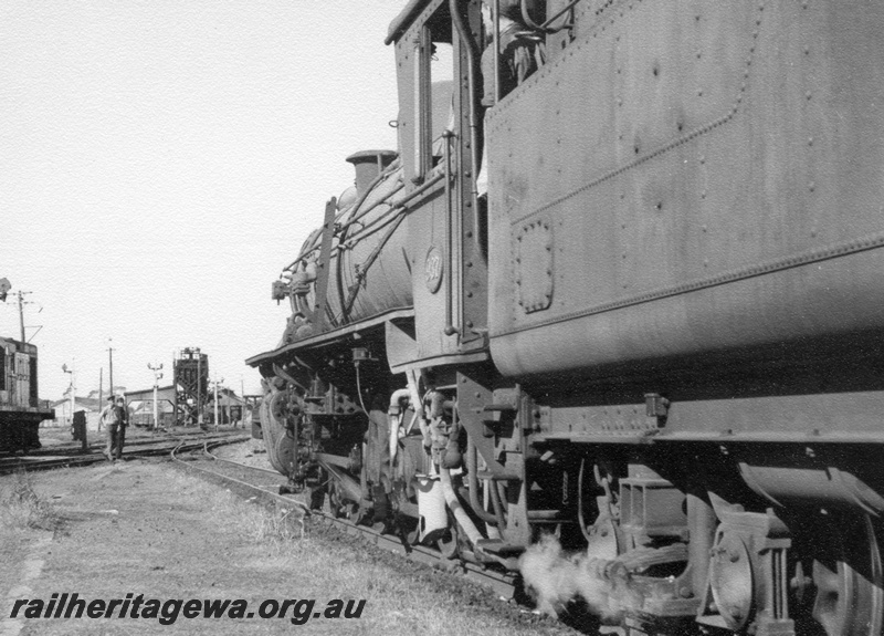 P17213
W class 937, coaling tower, bracket signals, Merredin, EGR line, view of side of loco taken from rear of tender at track level
