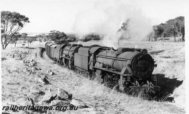 P17240
V class 1218 and V class 1219, double heading goods train, passing rocky outcrops, c1969

