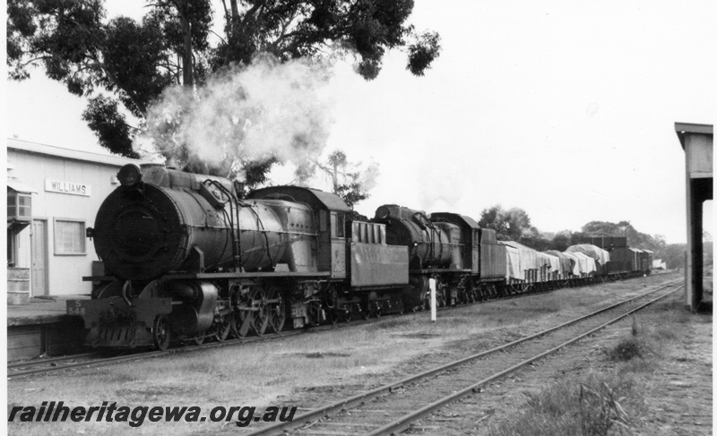 P17373
S class 548 and 542 steam locomotives on 104 goods at Williams. Part view of station buildings and platform with loop line and partial view of goods shed to right. Mileage post between locomotives. BN line.
