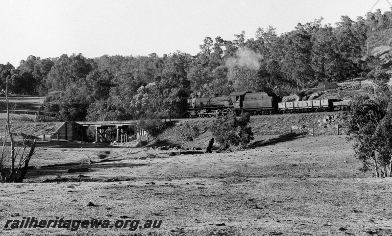 P17627
W class 942 steam locomotive working a Pinjarra to Dwellingup goods train. Note the timber trestle bridge in front of the train. PN line.

