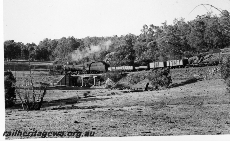 P17628
W class 942 steam locomotive working a Pinjarra to Dwellingup goods train crossing a timber trestle bridge. PN line. See P17627.
