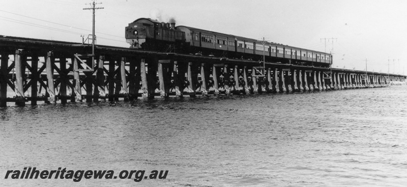 P17665
DD class 589 steam locomotive working the Tredale to Perth suburban passenger. SWR line. The train is crossing the former Bunbury bridge over the Swan River at East Perth. 

