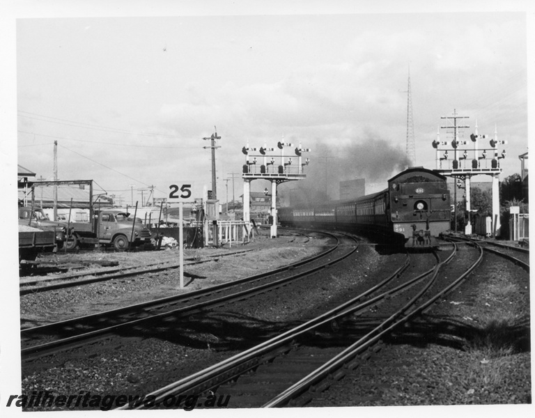 P17667
DD class 591, bunker first, on suburban passenger train, bracket signals, speed sign, Perth, c1966
