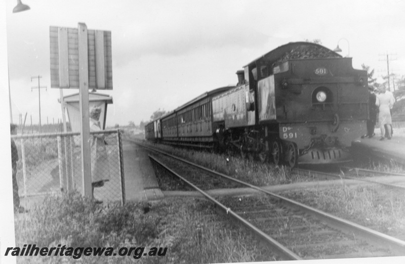 P17669
DD class 591, bunker first, on steam special, station platforms and shelter shed, pedestrian track crossing, c1966
