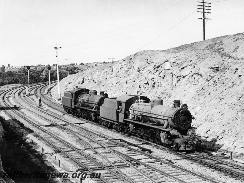 P17730
W class 936 & 944 steam locomotives travelling light engine from Avon Yard to Old Northam Loco at the east end of Avon Yard. GSR line. Note the automatic signal posts and the semaphore signal pole, signal wiring and narrow & standard gauge trackage.
