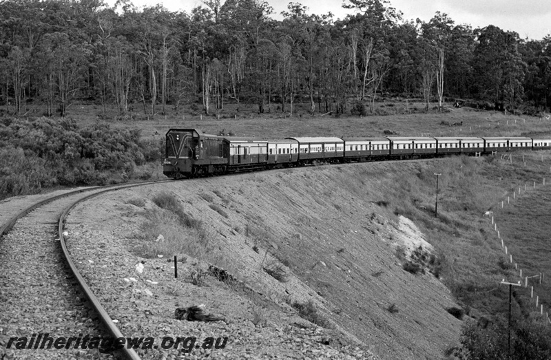 P17824
2 of 3 of A class 1504 diesel locomotive on a ARHS Tour train to Jarrahdale. SWR line. The make up of the train consisted of Z brakevan 531, AJ carriage 166, AYC carriages 512, 511, AYD 550 buffet car, AYC carriage 500, AY suburban carriage 454, AJ carriage 64 and ZJ brakevan 427. Note the formation works involved.
