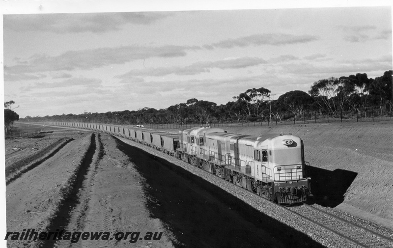 P17841
H class 5 diesel locomotive and 2 unidentified locomotives with a ballast train of WSH wagons at the 381 mile peg on Bonnievale - Stewart section of the standard gauge line.
