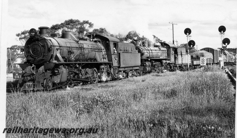 P18107
W class 947 and PR class 538 steam locomotives arriving Narrogin from Wickepin. NM line. Note the automatic signals to the right.
