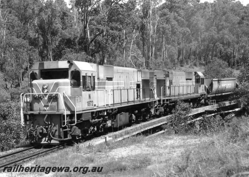 P18175
N class 1872 and N class 1876, double heading No 65 goods train comprising XG class hoppers from Kwinana to Collie, at 8 km post Brunswick to Collie section, BN line
