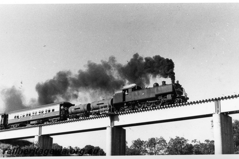 P18588
1 of 7 images of DM class 586 on ARHS tour train to Gingin on MR line, consist includes two tank wagons, crossing Upper Swan bridge, blowing black smoke from Newcastle coal
