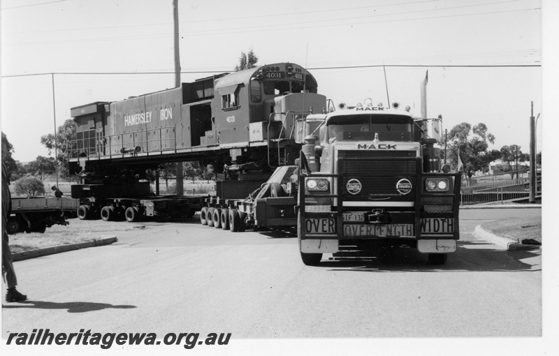P18818
Hamersley Iron (HI) M636 class 4031 on low loader at corner of Railway Pde. and Wood Street, Bassendean en route to Comeng for rebuilding. 
