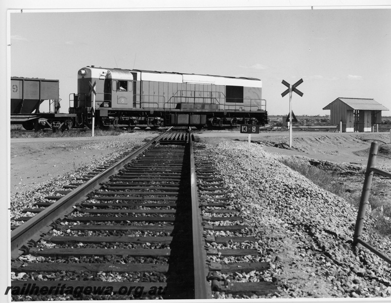 P18820
Goldsworthy Mining (GML) A class 8 hauling loaded iron ore train over the Newgold crossing of the Mount Newman Railway (13.8 km) near Port Hedland. 
