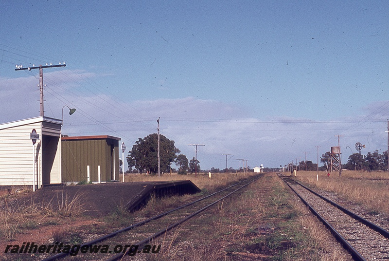 P19833
Station buildings, platform, station nameboards, tracks, trackside building, signals, water tower, windmill, North Dandalup, SWR line
