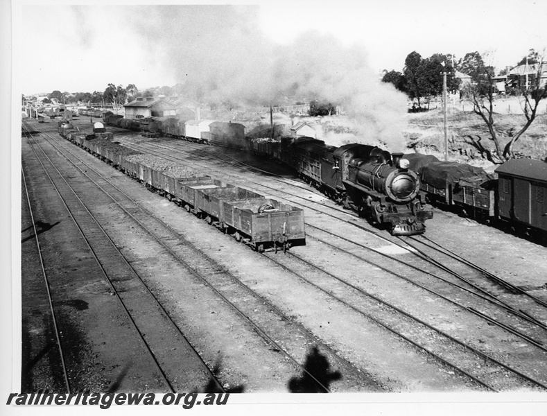 P20116
P class loco, on Perth bound goods train, departing yard, rakes of wagons, sidings, signals, pedestrian overpass, Northam, ER line
