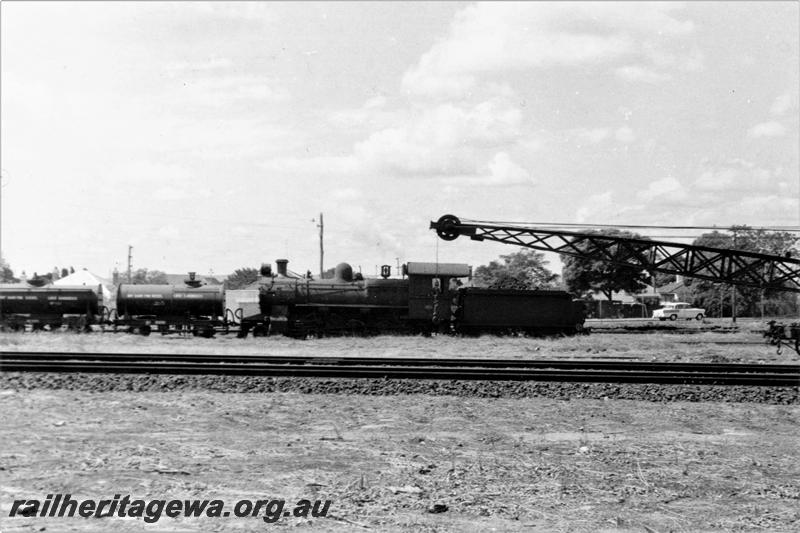P21119
FS class loco, water tanker wagons, mobile crane (part), tracks, East Perth running sheds, ER line, side view
