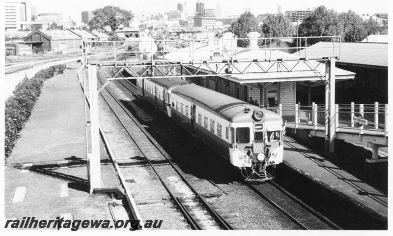 P21626
DMU 2 car set, Armadale bound, platform, station buildings, signal gantry, pedestrian ramp, Claisebrook, SWR line, side and end view from elevated position 
