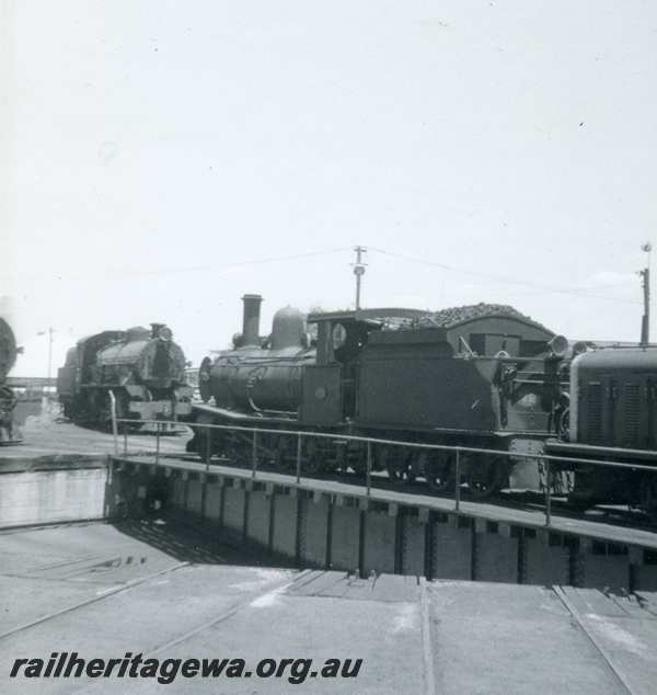P21789
Bunbury Roundhouse - G class 123 being pushed onto turntable by Z class. W class 907 in background. SWR line.
