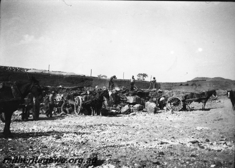 P22419
Preparing a railway water supply dam 1 of 3, horses, wagons, workers, view from ground level
