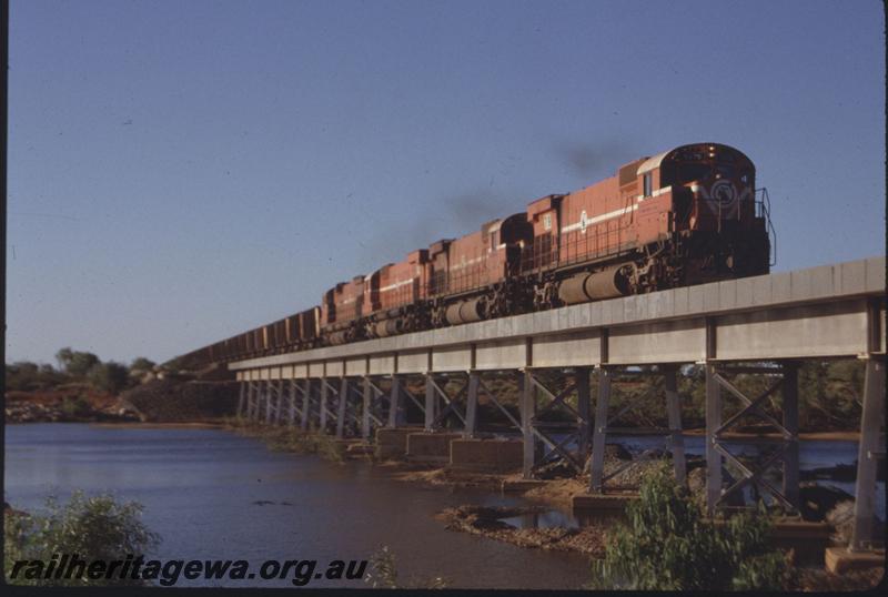 T01658
MT Newman Mining locos M636 class 5479, bridge, iron ore train.
