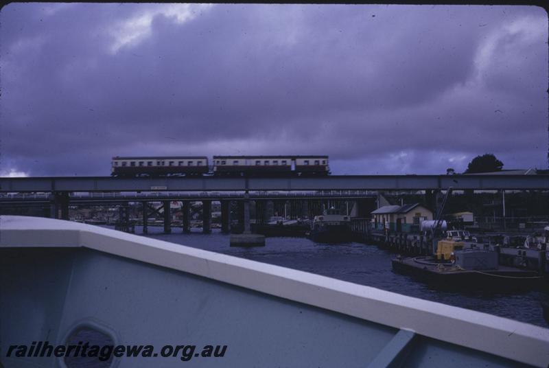 T01712
Railcar set, Fremantle Bridge, taken from boat approaching the bridge.
